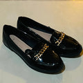 New Look Wide Fit Black Patent Chain Loafers with a gold tone metallic chain detail