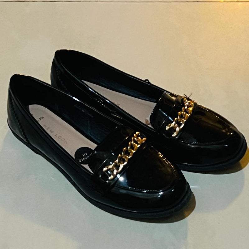 New Look Wide Fit Black Patent Chain Loafers with a gold tone metallic chain detail