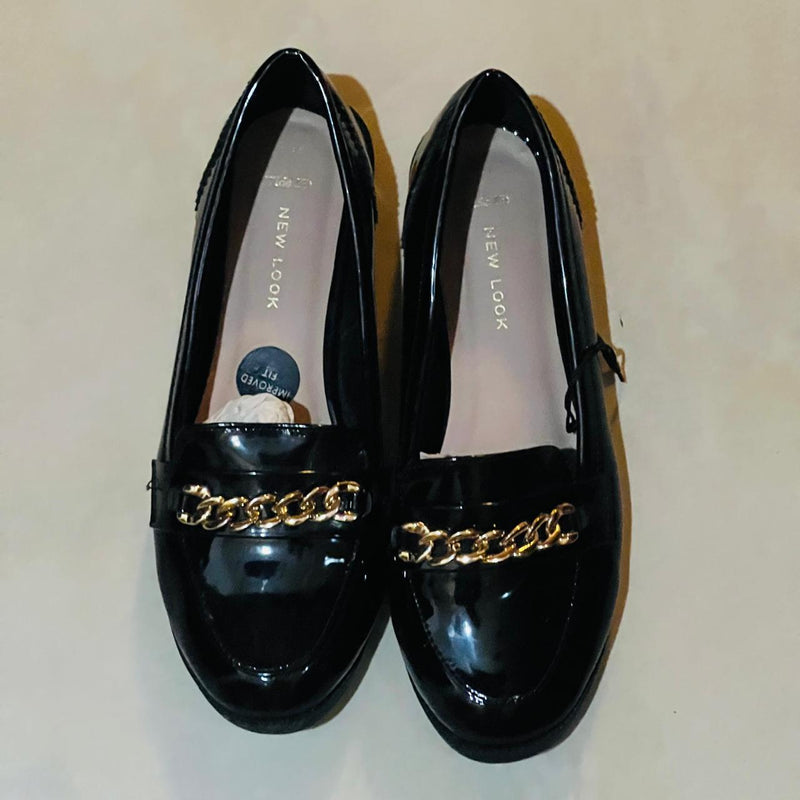 These New Look Wide Fit Black Patent Chain Loafers feature a shiny finish and a gold-tone metallic chain detail, www.letsell.pk